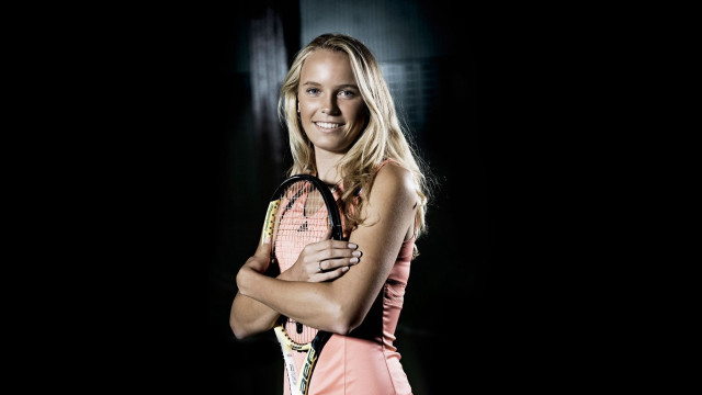 Woman holding tennis racket smiling #2 free wallpaper for desktop - medium preview image