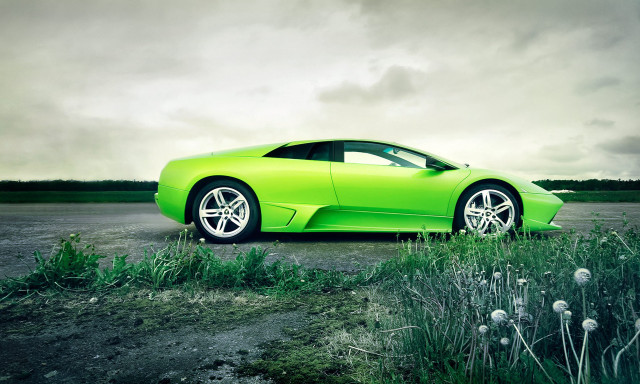 Green sports car parked field free wallpaper for desktop - medium preview image