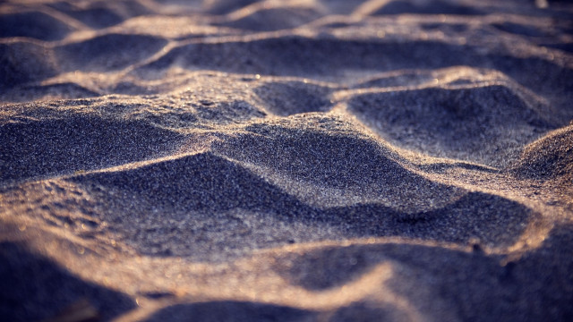 Sandy beach small waves blurry free wallpaper for desktop - medium preview image