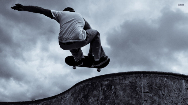 Man skateboarding cement wall cloudy free wallpaper for desktop - medium preview image