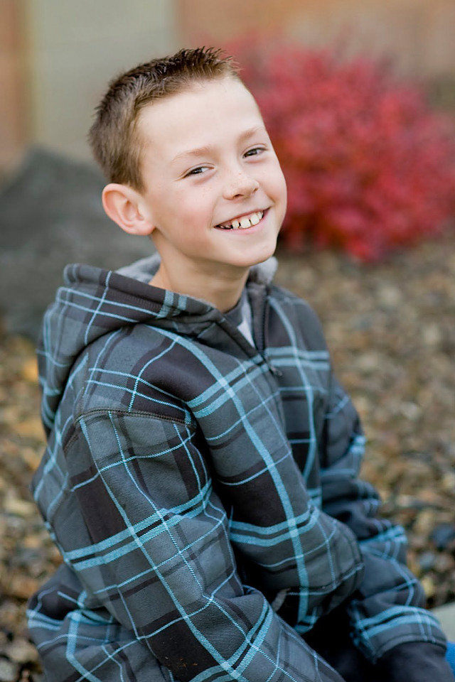 Young boy rock smiling camera free wallpaper for mobile - medium preview image