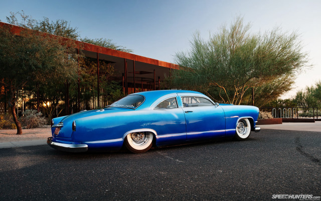 Blue car parked building trees free wallpaper for desktop - medium preview image