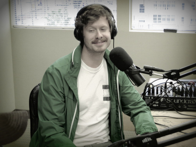 Man headphones microphone green jacket free wallpaper for desktop - medium preview image