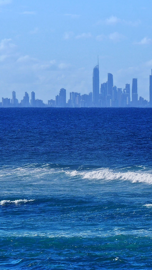 Man surfboard wave ocean city free wallpaper for mobile - medium preview image