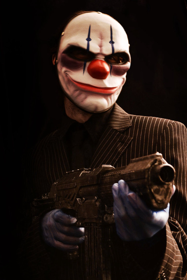 Clown gun suit mask holding free wallpaper for mobile - medium preview image