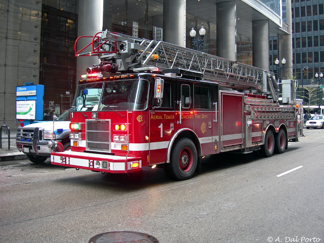 Fire truck parked building hose free wallpaper for desktop - medium preview image