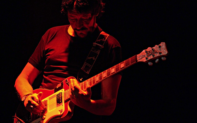 Man playing guitar dark room #2 free wallpaper for desktop - medium preview image