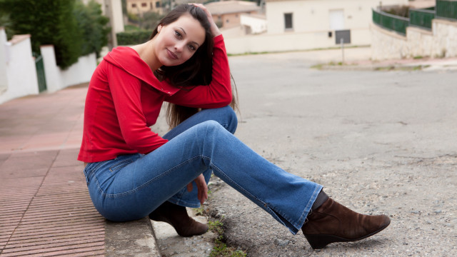 Woman sitting curb legs crossed free wallpaper for desktop - medium preview image