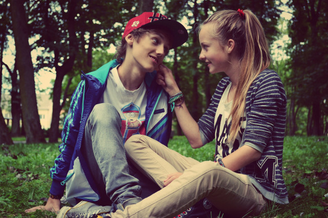 Boy girl sitting grass talking free wallpaper for desktop - medium preview image