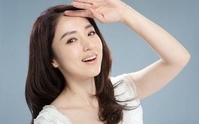 Woman white shirt holding hair #2 free wallpaper for desktop - medium preview image