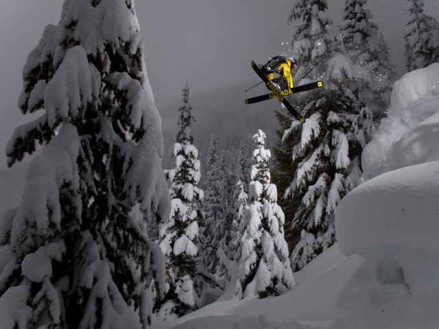 Snowboarder jumping snowy hill woods free wallpaper for desktop - medium preview image