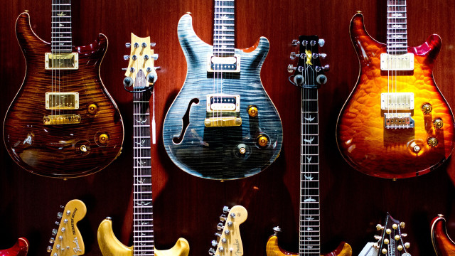 Guitars lined up on wall free wallpaper for desktop - medium preview image