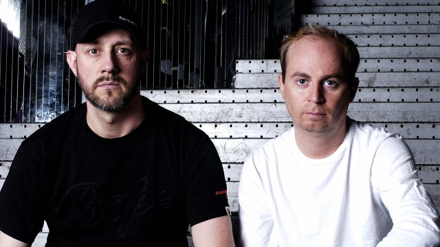 Two men sitting wall clock free wallpaper for desktop - medium preview image