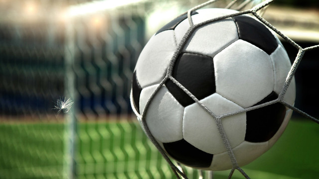 Soccer ball stuck in net free wallpaper for desktop - medium preview image