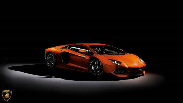Orange sports car dark room free wallpaper for desktop - medium preview image