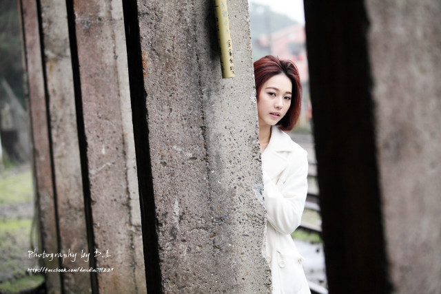 Woman leaning wall serious expression #2 free wallpaper for desktop - medium preview image