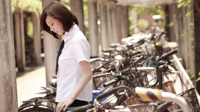 Woman standing bikes parking lot free wallpaper for desktop - medium preview image
