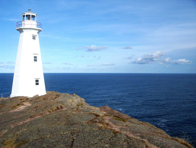Lighthouse rocky outcropping ocean blue free wallpaper for desktop - medium preview image