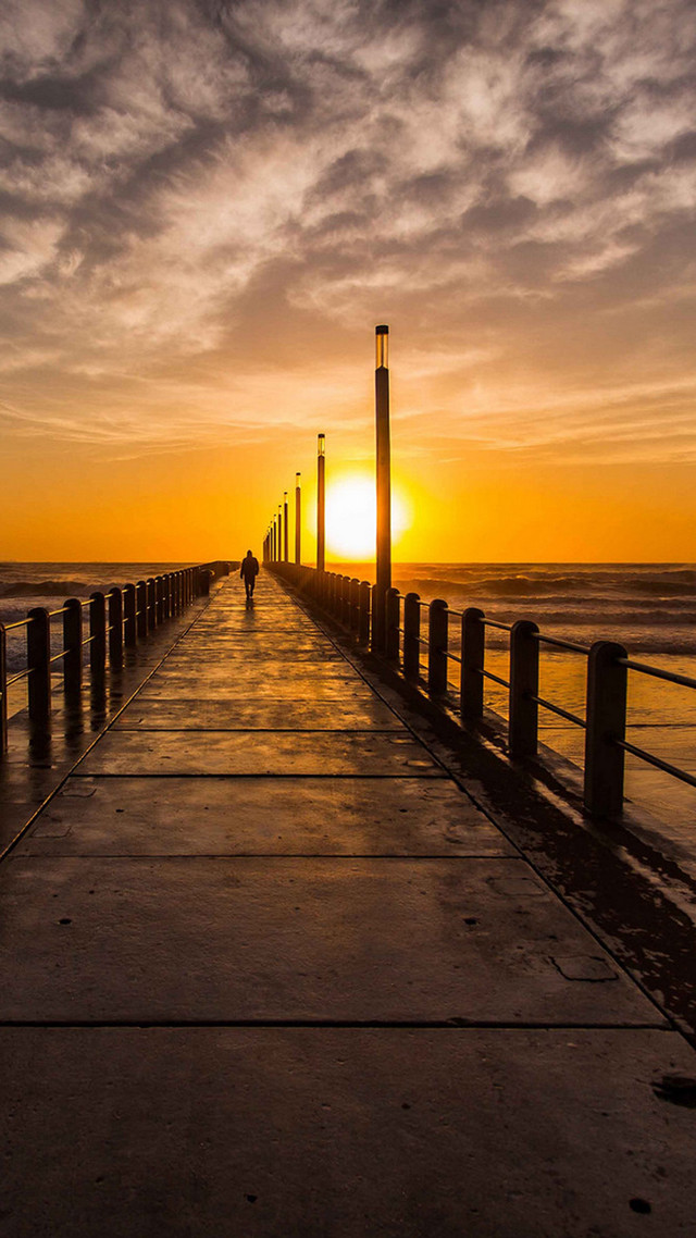 Person walking pier sunset ocean free wallpaper for mobile - medium preview image