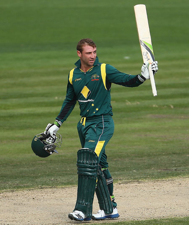 Man batting green uniform outdoors free wallpaper for mobile - medium preview image