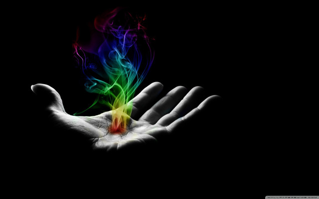 Hand holding colorful object dark free wallpaper for desktop - medium preview image