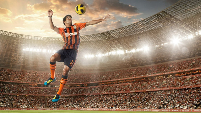 Man jumping stadium catching soccer free wallpaper for desktop - medium preview image