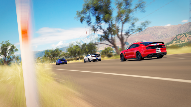 Red car driving road forest #6 free wallpaper for desktop - medium preview image