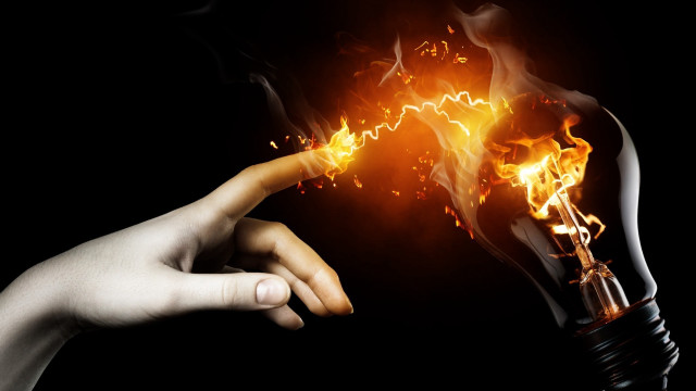 Hand holding lightbulb flame pointing free wallpaper for desktop - medium preview image