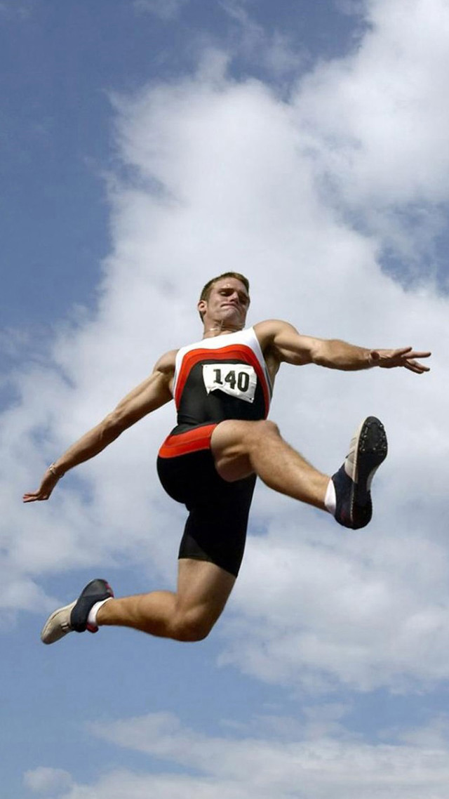 Man jumping competition event grass free wallpaper for mobile - medium preview image