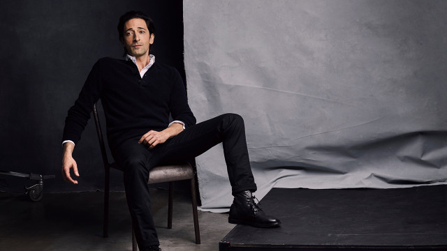 Man sitting portrait black clothing free wallpaper for desktop - medium preview image