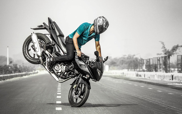 Man motorcycle trick road helmet free wallpaper for desktop - medium preview image