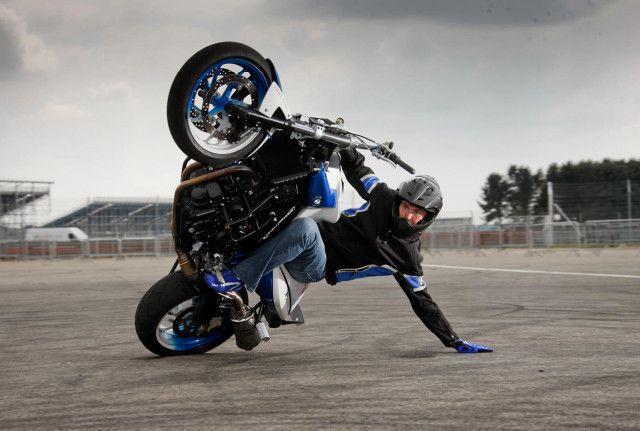 Man wheelie motorcycle parking lot free wallpaper for desktop - medium preview image