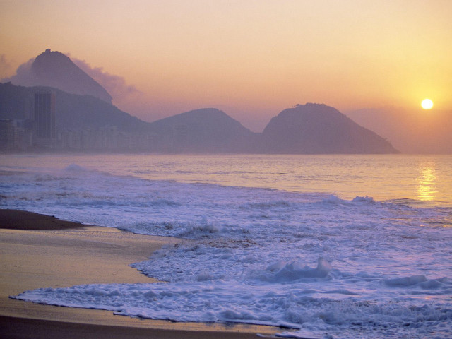 Sunset ocean beach mountains person free wallpaper for desktop - medium preview image