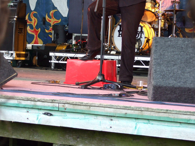 Man standing stage microphone speaker free wallpaper for desktop - medium preview image