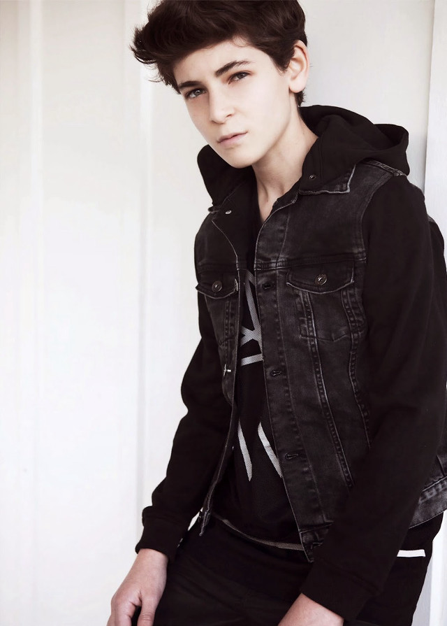 Young man black jacket leaning free wallpaper for mobile - medium preview image