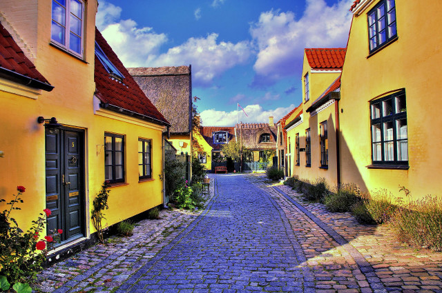 Cobblestone street yellow buildings red free wallpaper for desktop - medium preview image