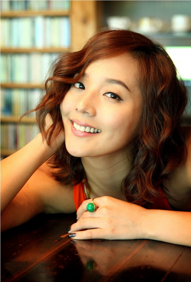 Red haired woman smiling table free wallpaper for mobile - medium preview image