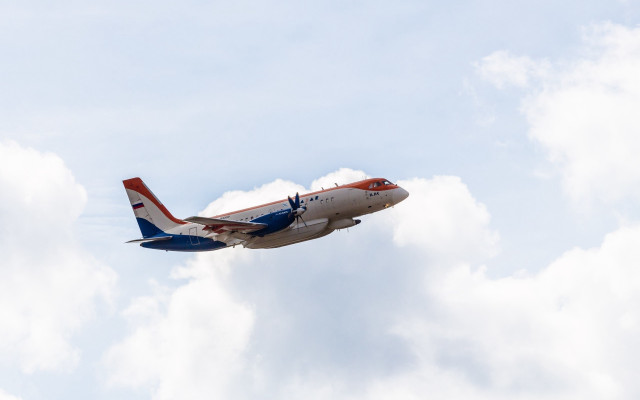 Jetliner red blue tail cloudy free wallpaper for desktop - medium preview image