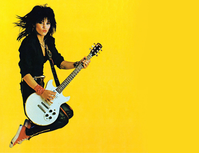 Woman jumping guitar yellow background free wallpaper for desktop - medium preview image