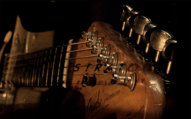 Guitar closeup black background #2 free wallpaper for desktop - medium preview image