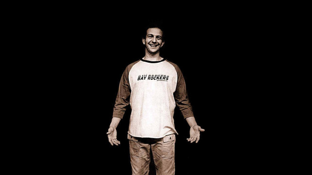 Man skateboard dark smiling camera free wallpaper for desktop - medium preview image