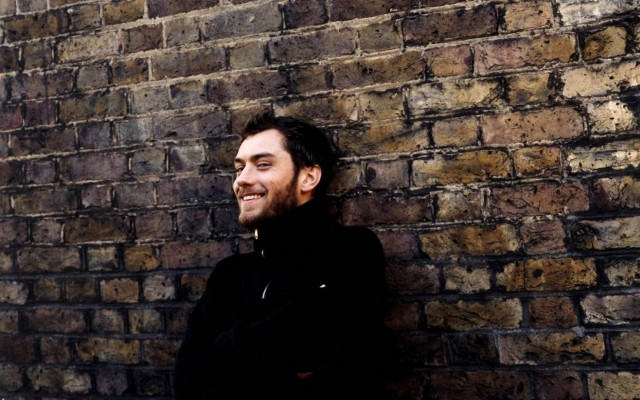 Man standing brick wall arms #2 free wallpaper for desktop - medium preview image