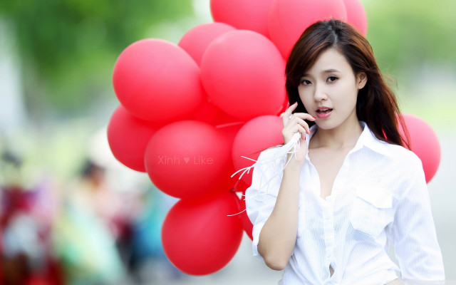 Woman holding red balloons talking free wallpaper for desktop - medium preview image