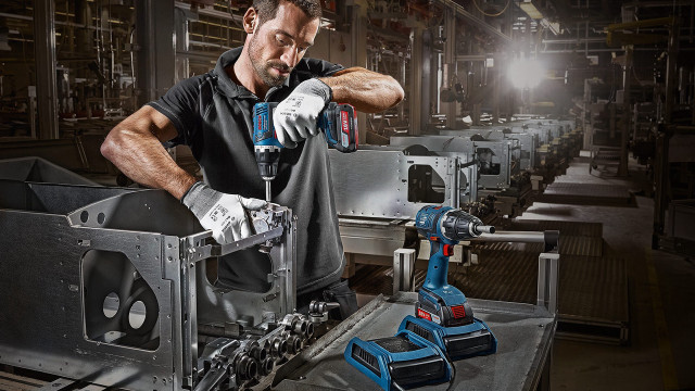 Man working machine factory spotlight free wallpaper for desktop - medium preview image