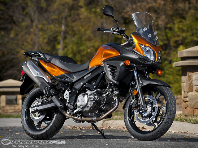 Motorcycle parked road stone wall free wallpaper for desktop - medium preview image