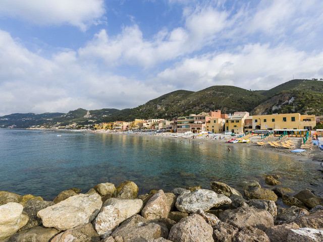 Beach rocks buildings people water free wallpaper for desktop - medium preview image