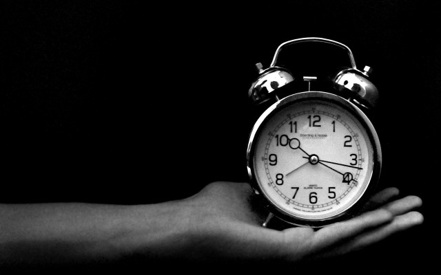 Person holding alarm clock dark #2 free wallpaper for desktop - medium preview image