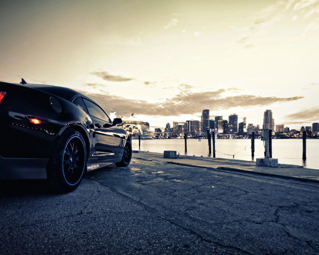 Black car road water city free wallpaper for desktop - medium preview image