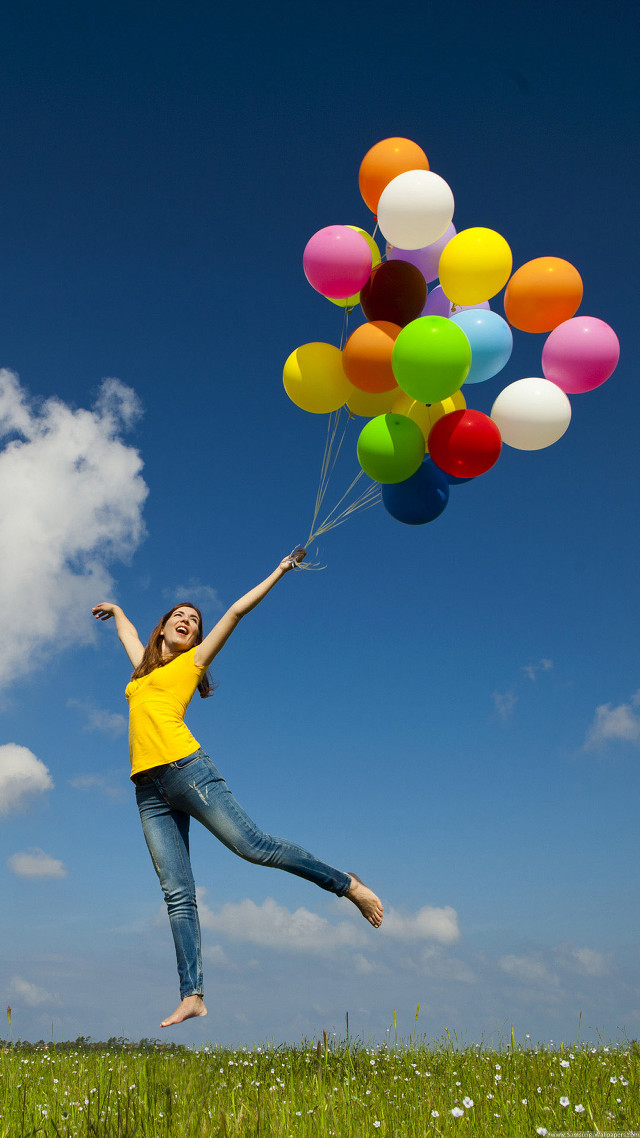 Woman yellow shirt holding balloons free wallpaper for mobile - medium preview image