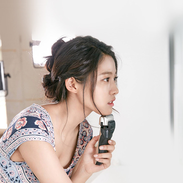 Woman holding hair dryer mirror free wallpaper for tablet - medium preview image